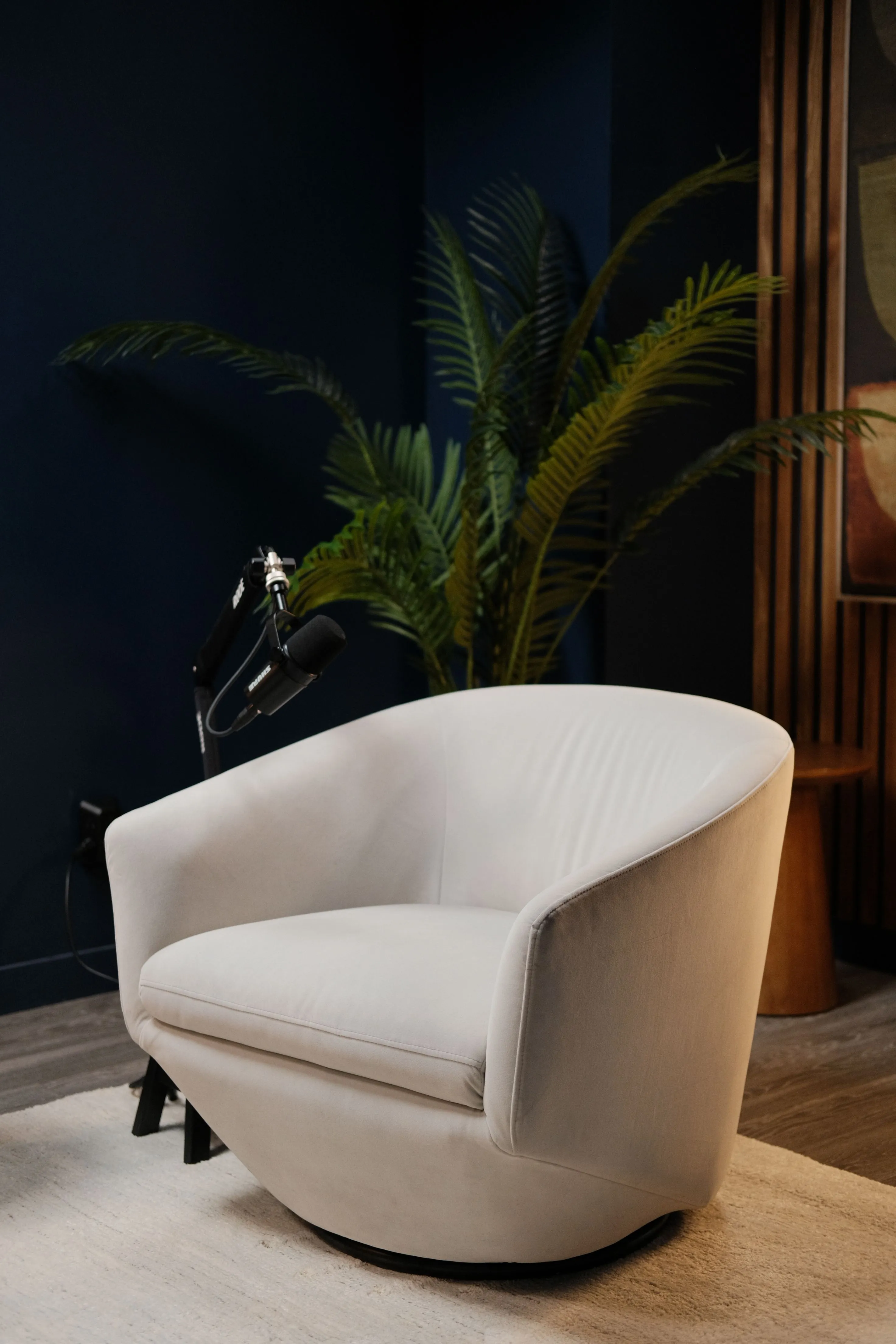 Fauteuil crème installé devant un micro dans le studio du Podtalk